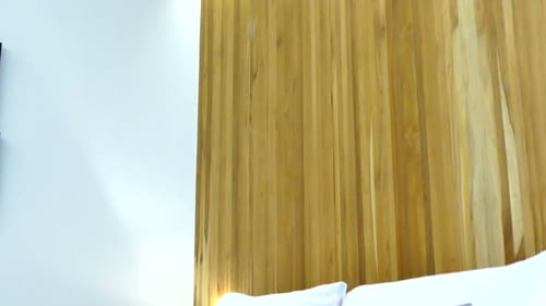 Modern Bedroom Interior with White Linens and Wood Headboard