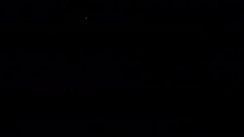 Colorful Particles Bursting on Black Background Close Up