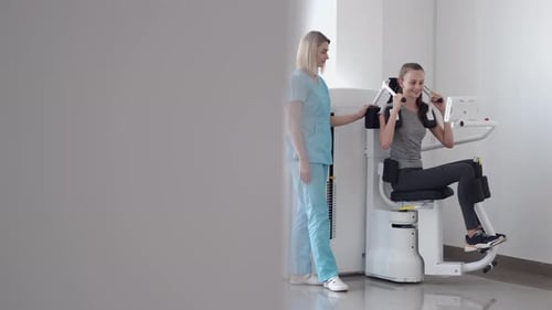 Patient Using Sports Equipment and Doing Exercises in Gym