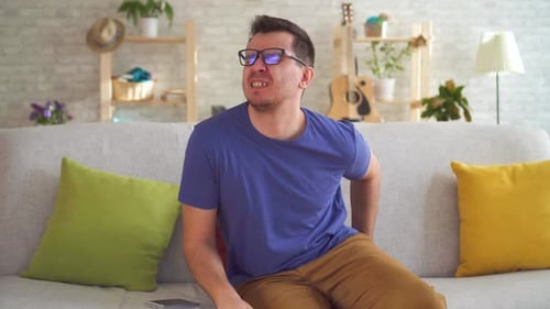 Portrait Unhealthy Man Feeling Discomfort Hemorrhoid Pain Sitting on the Couch