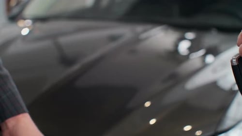 Famale Hand Gives a Car Keys To Male Hand in the Car Dealership Close Up, Unrecognized Auto Seller
