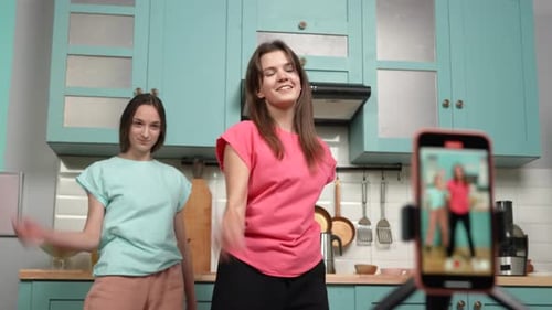 Two Young Women Dancing Together in Kitchen