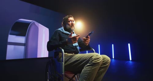 Mature Speaker with Disability Showing New Cellphone on Stage