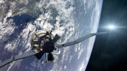 Satellite Deploying Solar Panels Orbiting Earth in Space