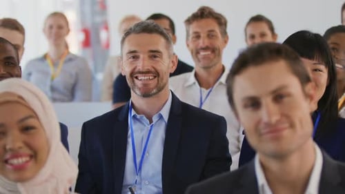Diverse Group Attends Corporate Event and Raises Hands