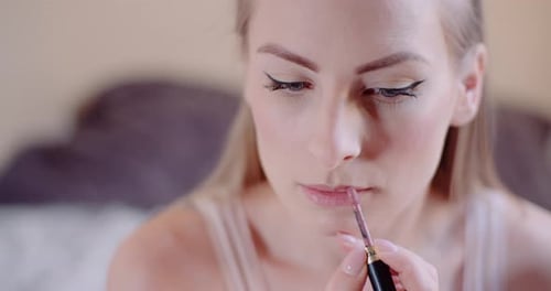 Woman Doing Makeup and Painting Lips with Paintbrush