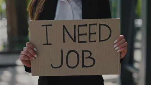 Close Up of Woman Holding Banner with Phrase I Need Job