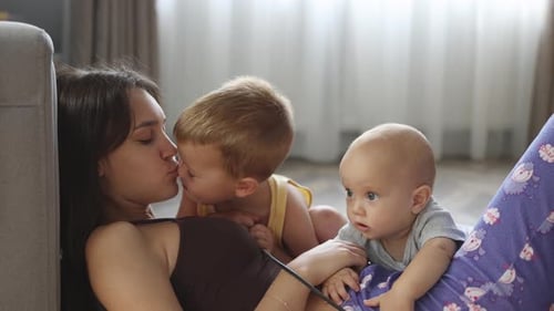 Mother and Children Relaxing Indoors at Home