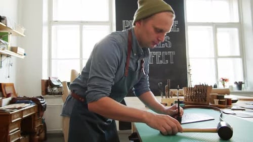 Male Worker Making Leather Belt in Workshop