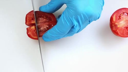 Fresh Tomato Cut Close Up on White Kitchen Board