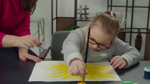 Girl and Woman Painting Yellow Art Together