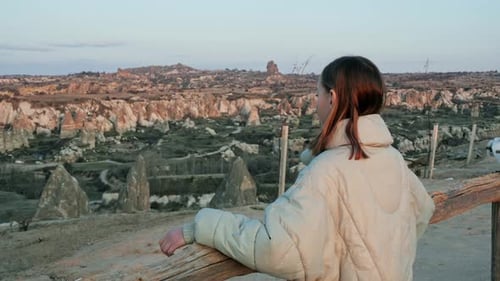 Girl on Ridge Overlooking Vast Rural Landscape