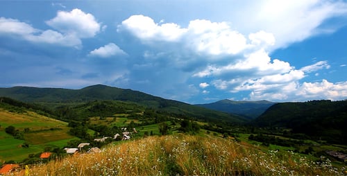 Picturesque Mountain Valley with Rolling Clouds