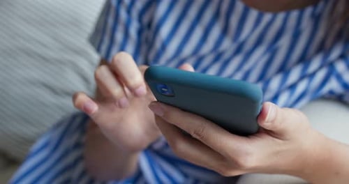 Woman Using Smartphone Close Up at Home