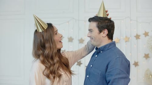 Loving Couple Celebrates Birthday With Hats and Smiles