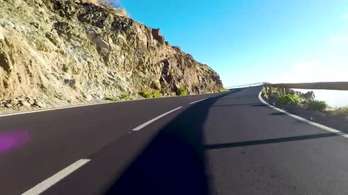 Estrada longa na montanha com montagens na frente e efeito da luz solar - ponto de vista do solo