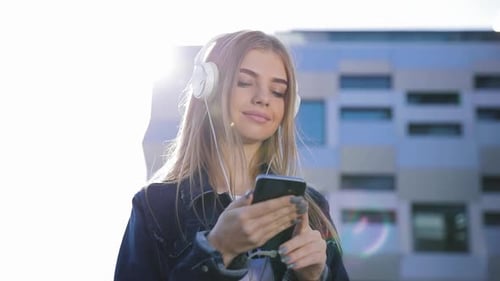 Woman Listening to Music in Urban Setting