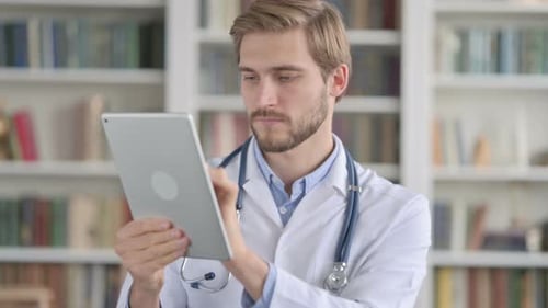 Doctor Using Tablet in Front of Bookshelf