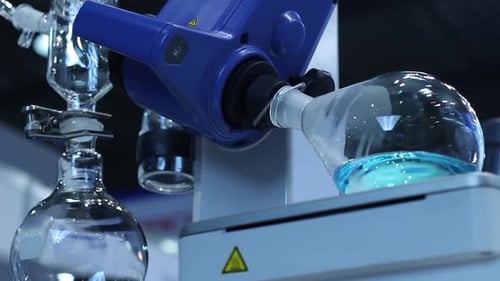 Laboratory Flasks with Rotating Blue Liquid