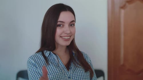 Smiling Young Woman Gives Thumbs Up Gesture