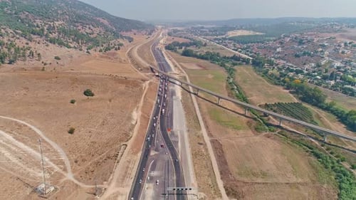 Aerial footage of large highway construction project with tunnels and bridges