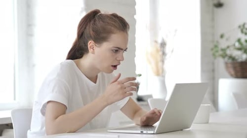 Shocked Young Woman Reacts to Laptop Screen