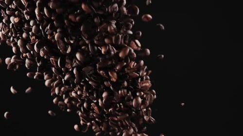 Falling Coffee Beans on Black Background, Close-Up