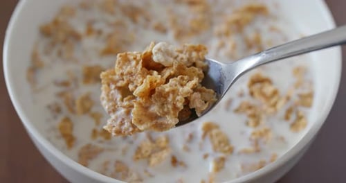 Crispy Cereal with Milk on Spoon Close-Up