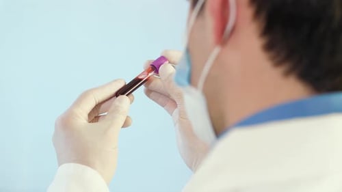 Medical Professional Analyzing Blood Sample in Test Tube