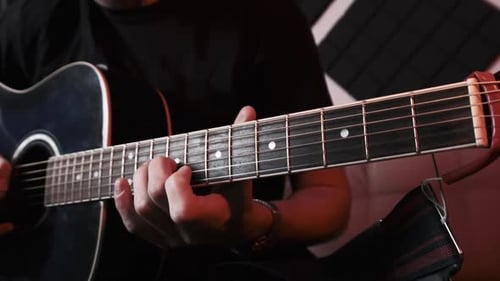 Young Man Playing Acoustic Guitar While Sitting Sofa Home Recording Studio