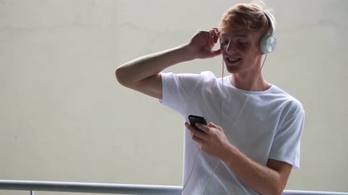 Young Adult Listening to Music With Headphones