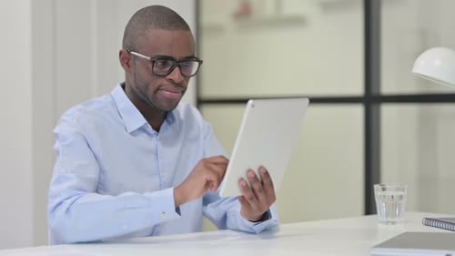 Adult Uses Digital Tablet Device at Office Desk