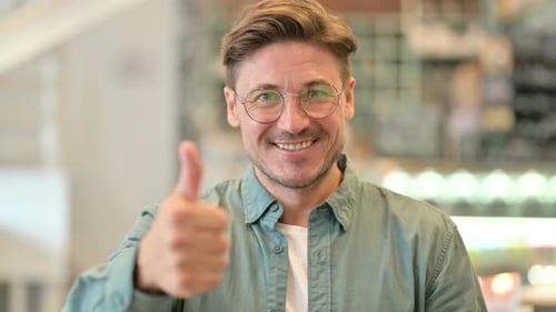 Smiling Man Gives Thumbs Up Approval Close Up