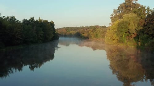 Beautiful morning, summer flight over the river. Fog, trees.