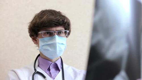 Doctor Examines X-Ray in Hospital Setting