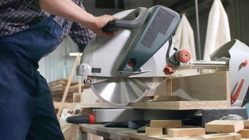 Woodworker Using Power Saw in Workshop
