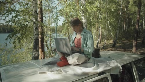 Young Adult Working on Laptop in Nature