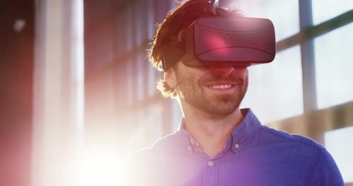 Man Uses Virtual Reality Headset in Bright Office