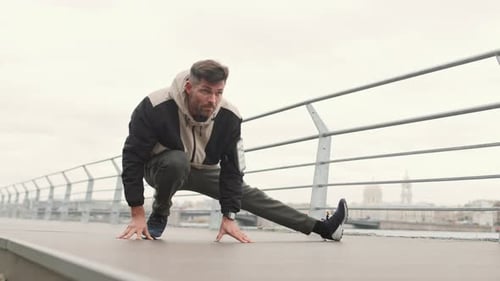 Sportsman Doing Warm-up before Run