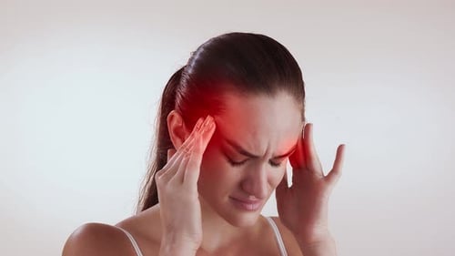 Young Adult Woman with Headache Holding Temples