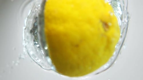 Lemon Splashing into Water Close Up