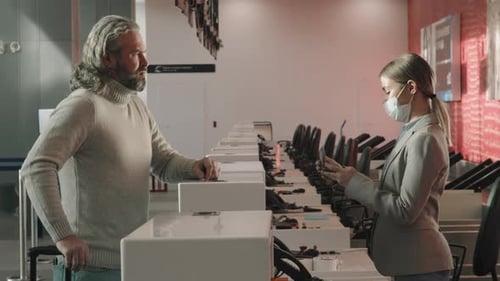 Airport Employee Checking Travel Documents and Passport