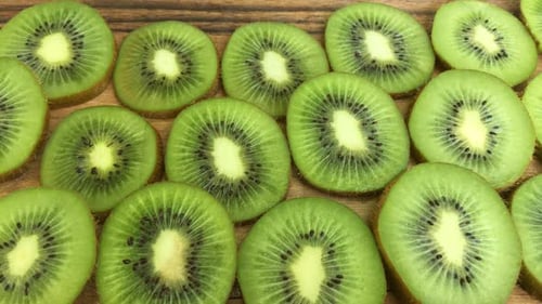 Kiwi Fruit Slices Close Up on Wood