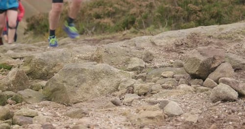 People Trail Running on Rocky Terrain Outdoors
