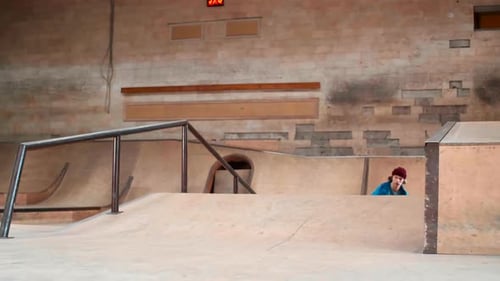 Young Man Performing Trick in Skating Arena