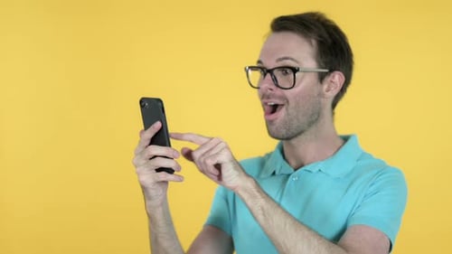 Man Celebrates While Talking on Mobile Phone