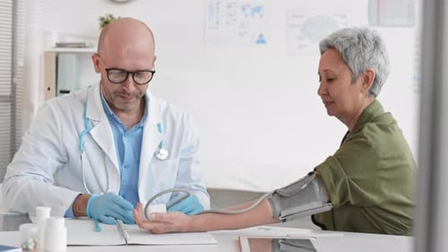 Doctor Checks Senior Woman's Blood Pressure