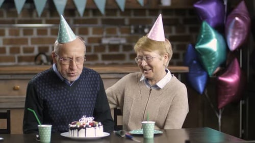 Senior Couple Celebrates Birthday with Cake and Love