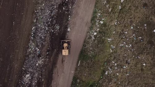 Bulldozer Pushes Trash at Rural Landfill