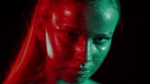 Fashion Portrait of Woman's Face in Glitter and Under Neon Lights in 80's Style